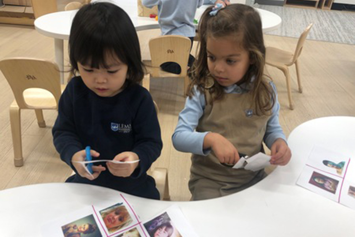 Two girls create art project.