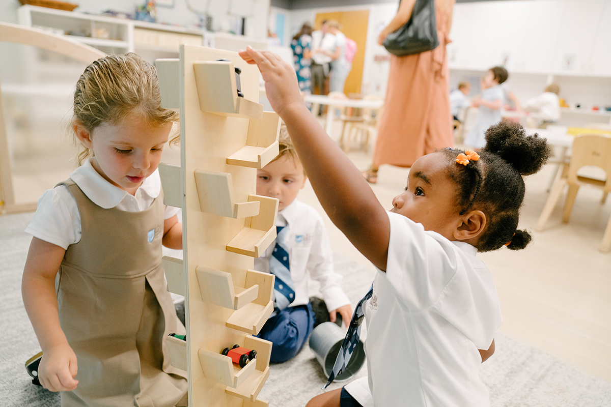 Children playing with a tower of toys.