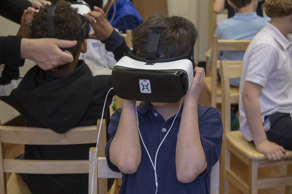 Student watches an immersive movie wearing a VR headset.