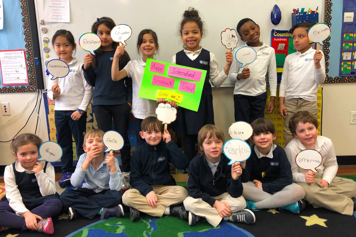 Children holding up International Women's Day signs