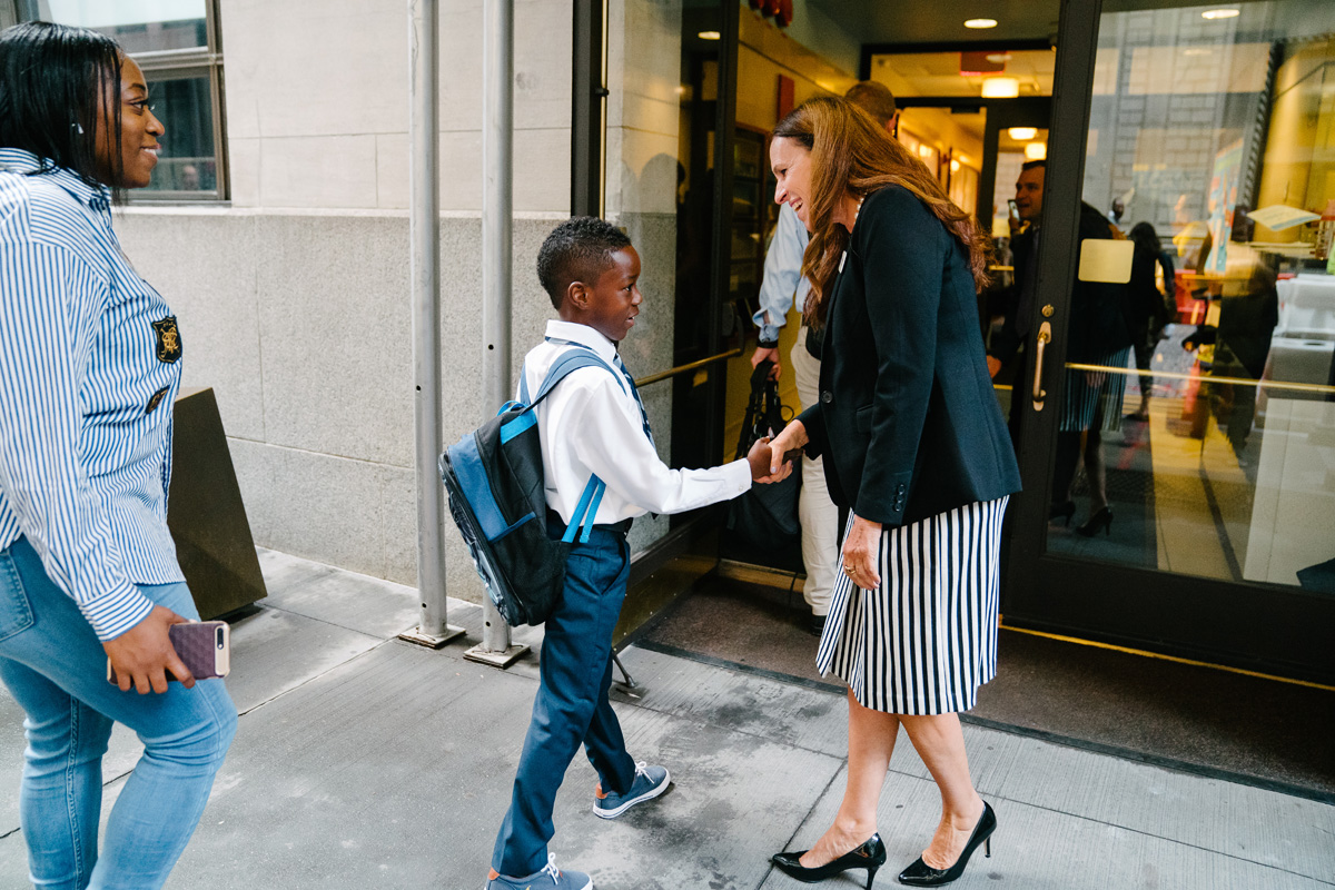 Boy shakes hand of Maria Castelluccio