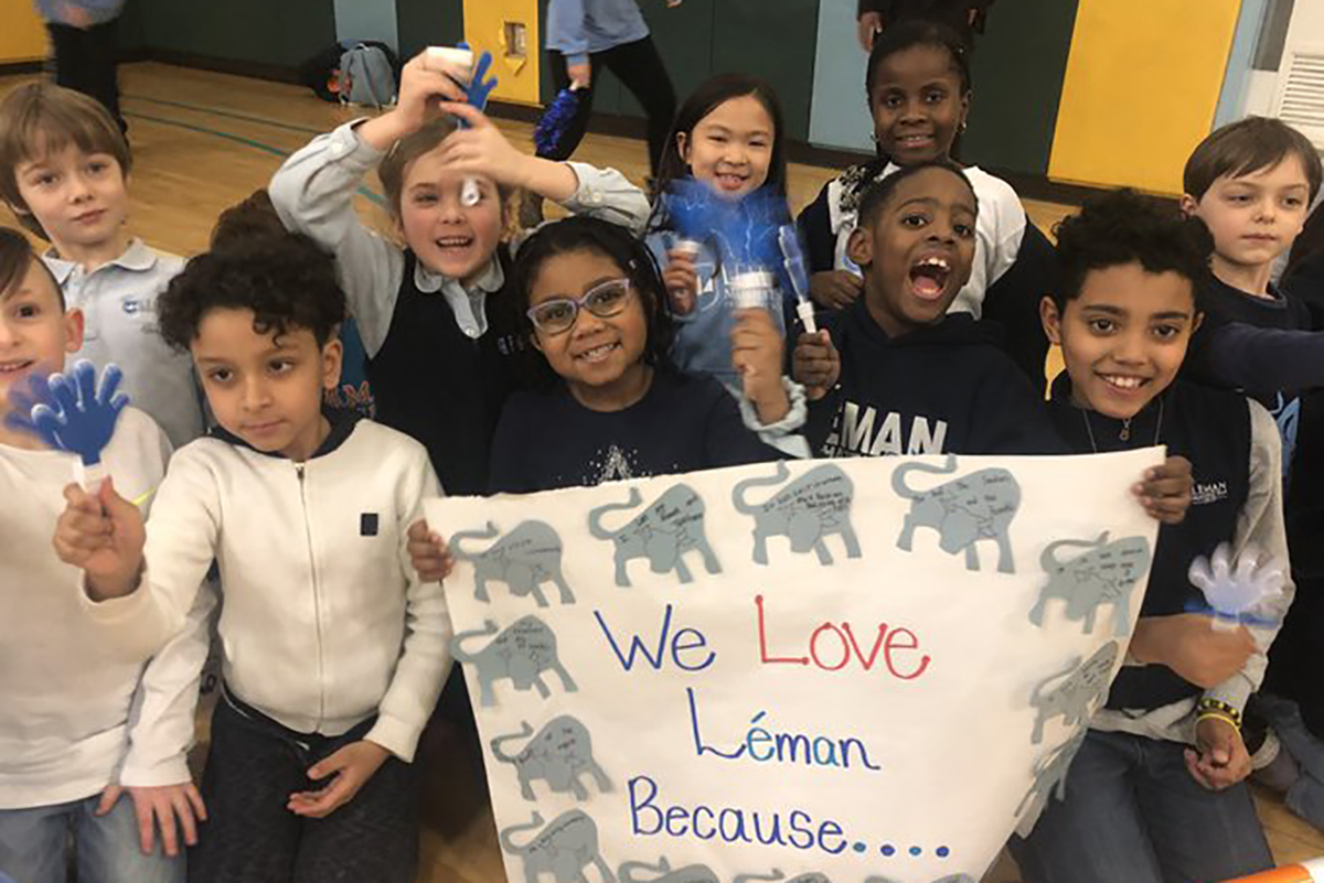 Kids holding up sign