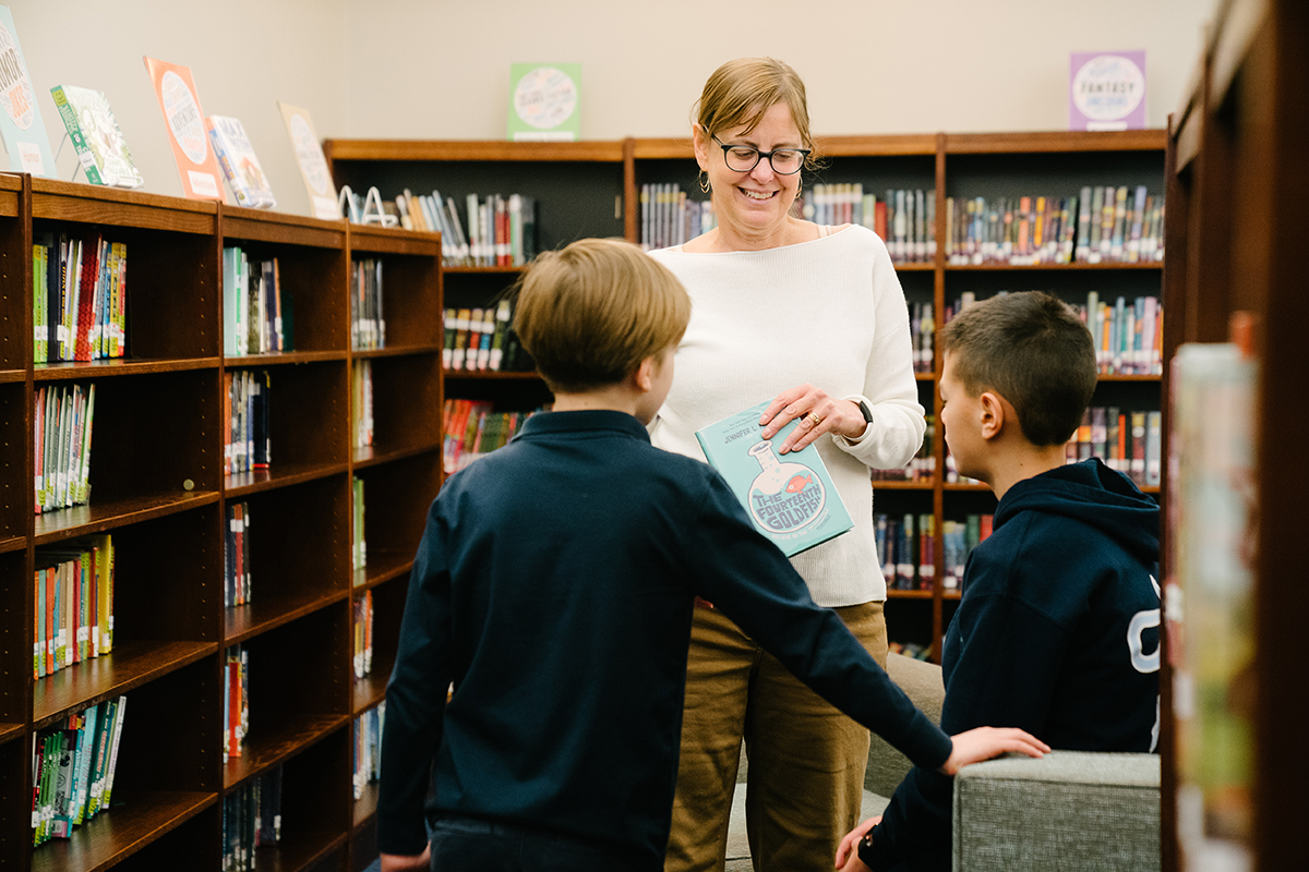 Teacher and kids in library