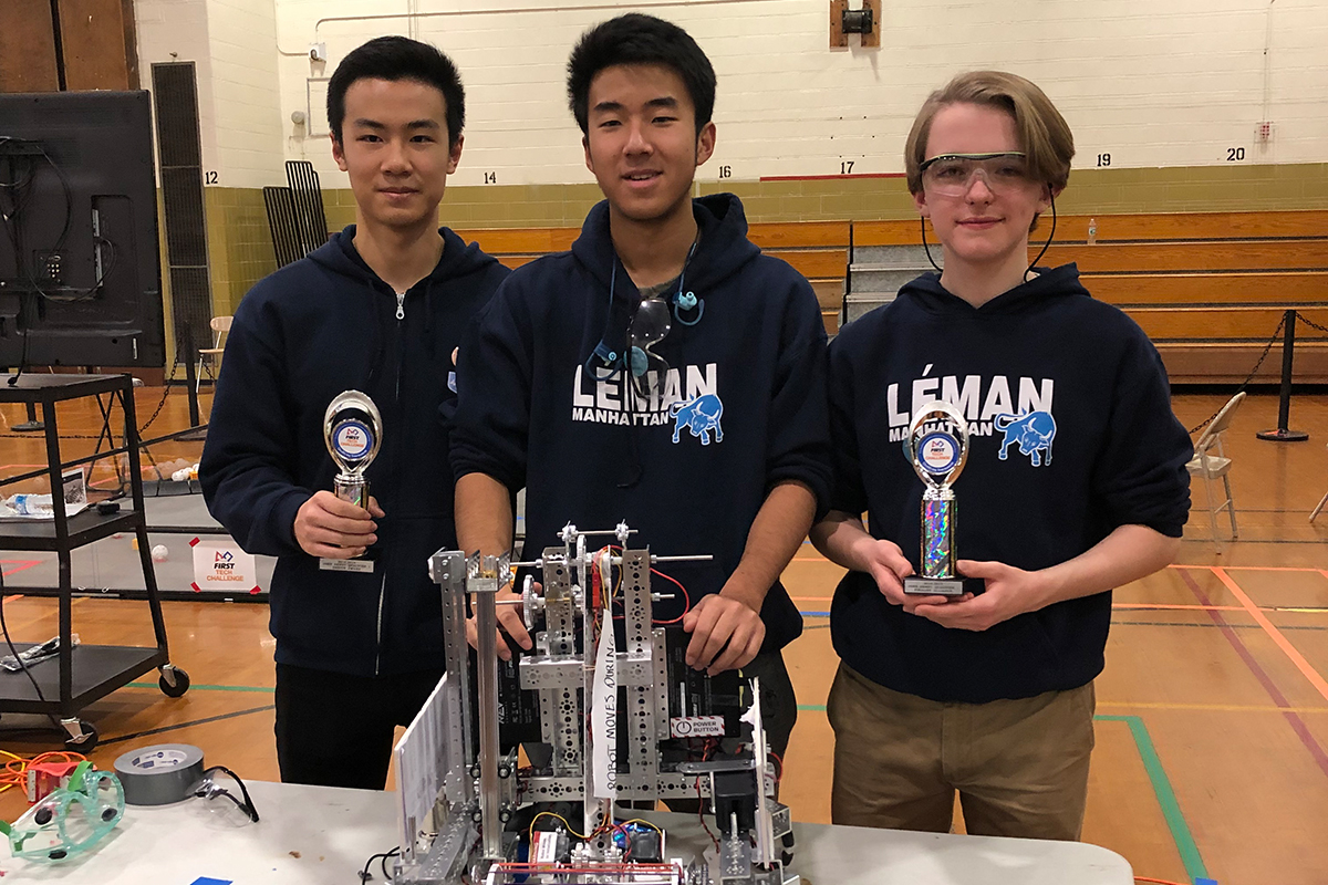 High Schoolers pose with award-winning robot