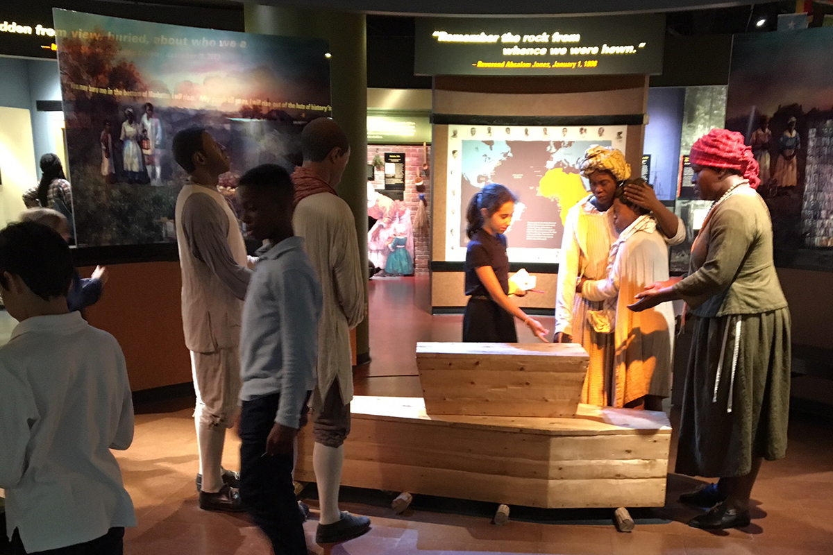 Students observe museum exhibit 