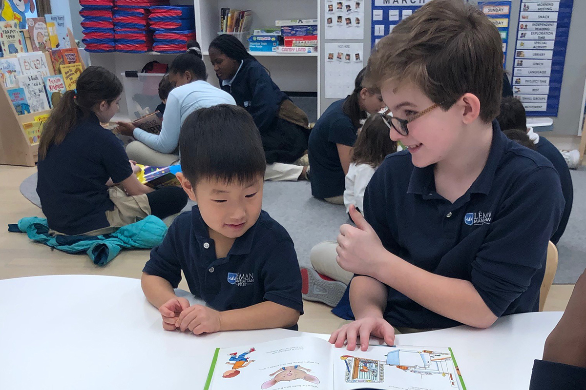 Two boys reading together